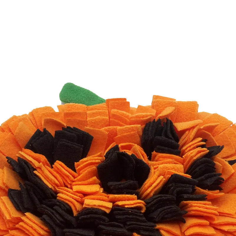 Orange pumpkin-shaped dog snuffle mat with textured surface for slow feeding and scent work training.