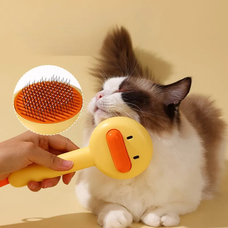 Small yellow duck-shaped pet grooming comb with needle tines for hair removal from cats and dogs.