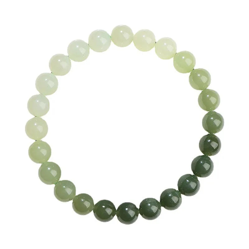 Natural clear water Hetian jade ball bracelet with round beads on a wrist.
