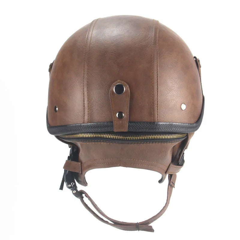 Retro black leather motorcycle helmet with a half-visor on a background.