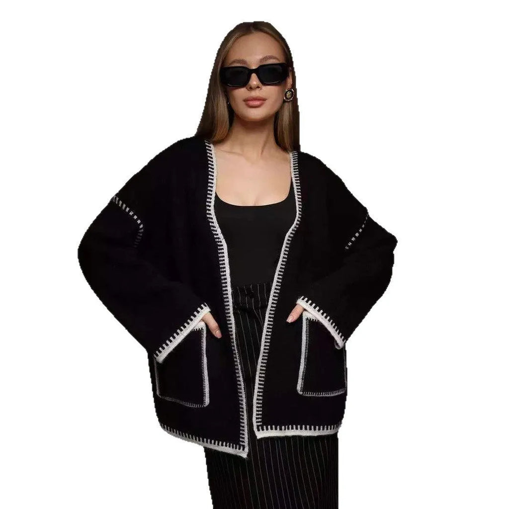 Lace-up front knitted cardigan in a camel colour, shown loose and open over a top.