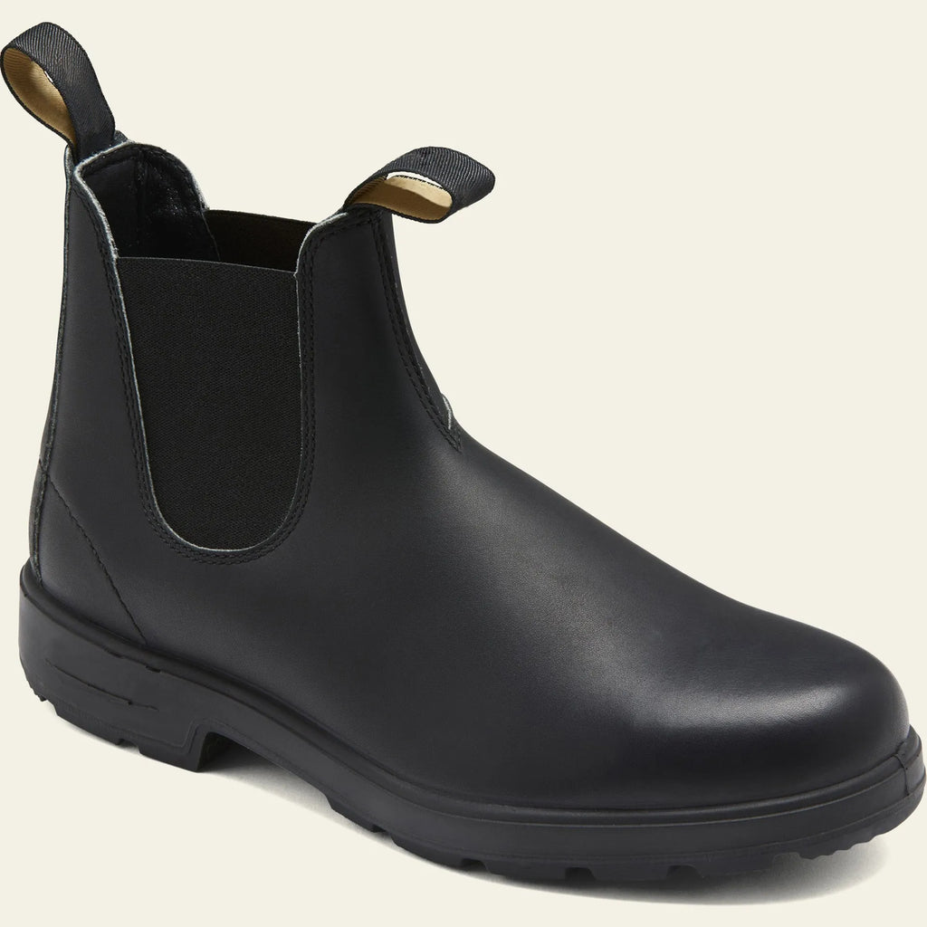 Vintage grey unisex Chelsea boots on a wooden floor, showing frosted PU upper, round toe, low heel, and car stitch detail.