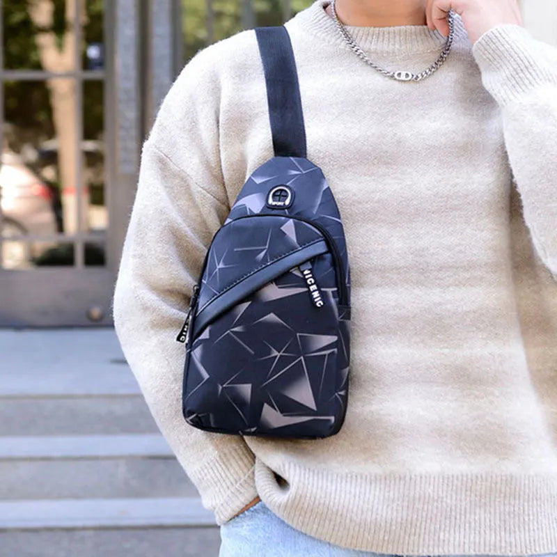 Blue men's crossbody sling bag with earphone hole, made from Oxford cloth, showing front zipper and strap.