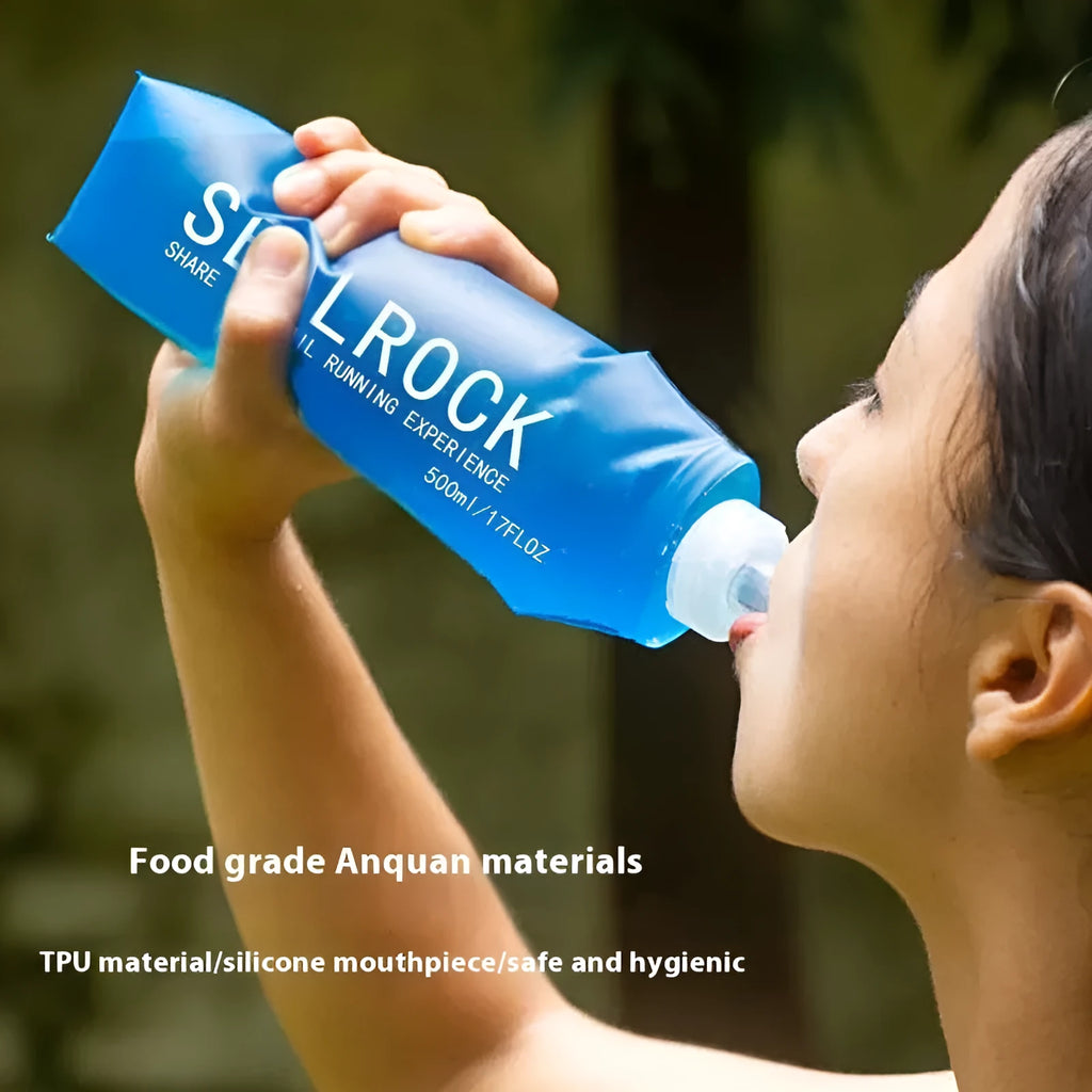 Mountain Cliking portable plastic straw with black clip attached to a green backpack strap