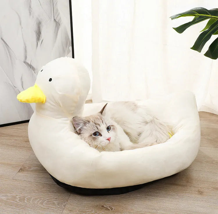 Blue duck-shaped fluffy pet bed for a small dog, showing raised rim and soft material.