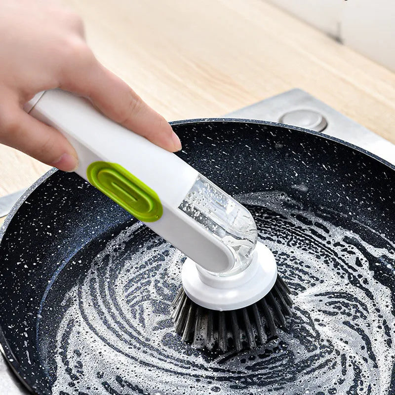 White and green liquid-filled cleaning brush with soap dispenser handle and two brush heads for kitchen cleaning