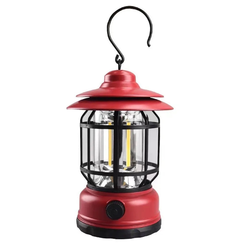 Portable head lamp camping lantern in dark green, showing compact size for hands-free use.