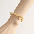 Gold rutilated quartz crystal bracelet with a ringing bell charm in Korean style.