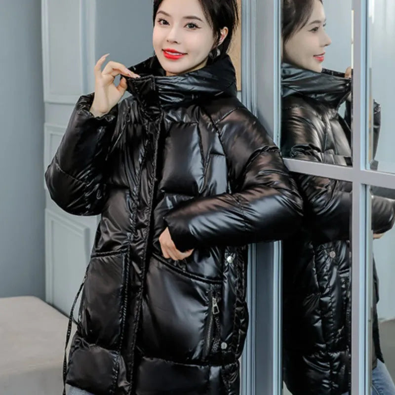 Women's loose-fitting long sleeve hooded jacket in black, shown on a hanger.