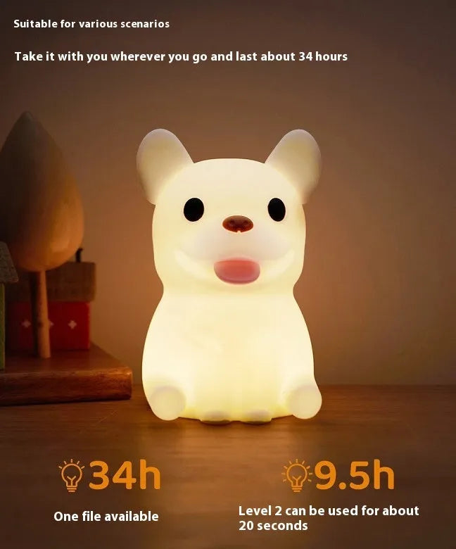 A cartoon bull-shaped silicone USB night light with a dimming function on a bedside table.