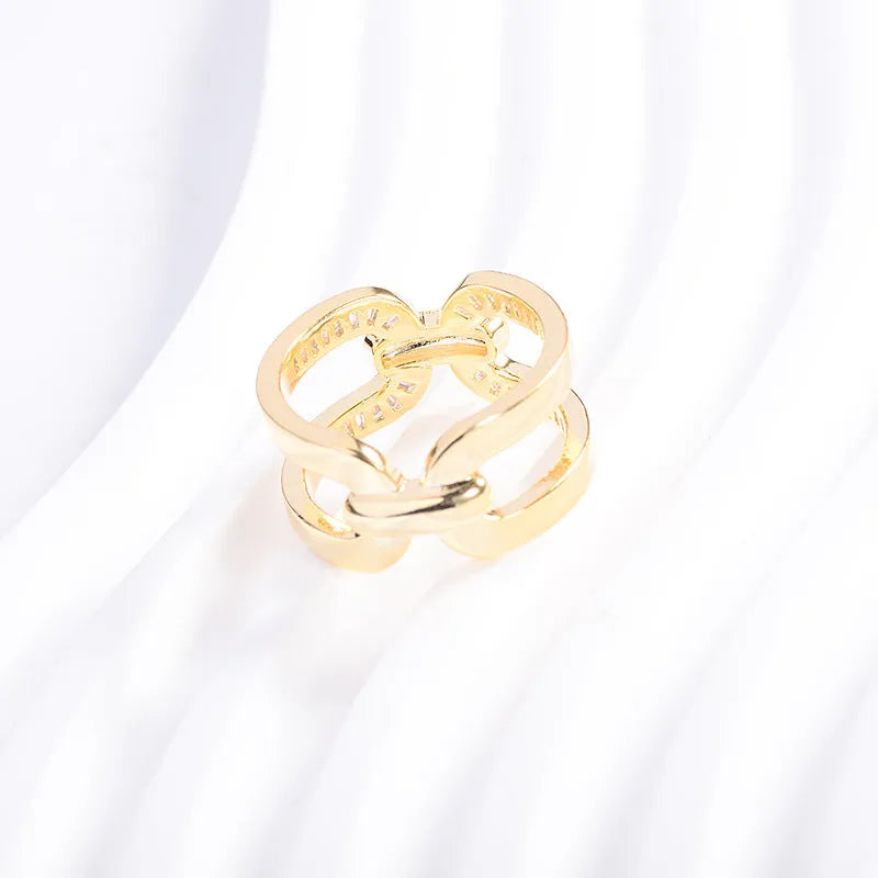 Gold electroplated copper round scarf ring with geometric shape on a silk scarf