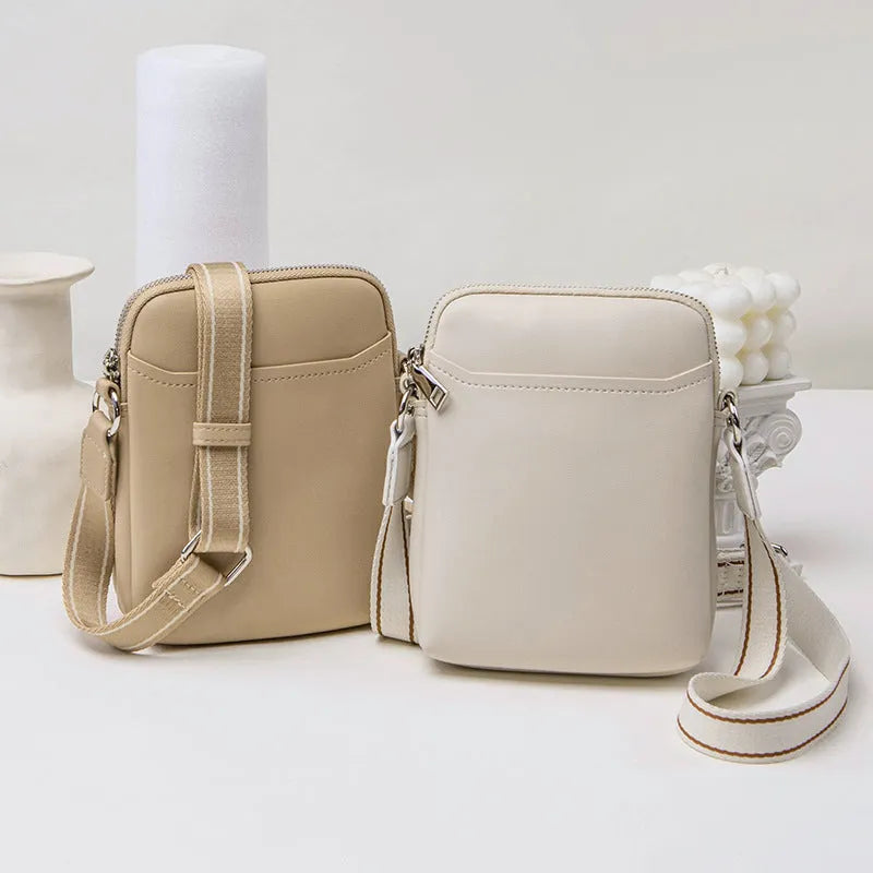 Solid colour PU leather crossbody shoulder bag for women with adjustable strap.