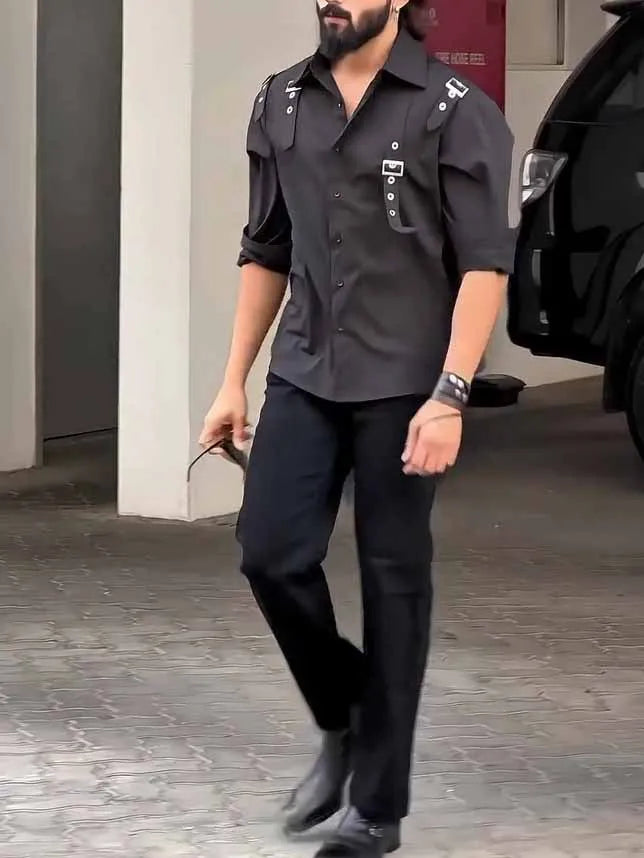 Man wearing a black utility-style button-up polyester shirt with a regular fit.