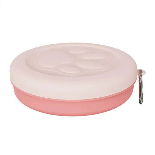 Collapsed and open views of a pink silicone dog bowl with matching sealing lid, next to a dog lead.