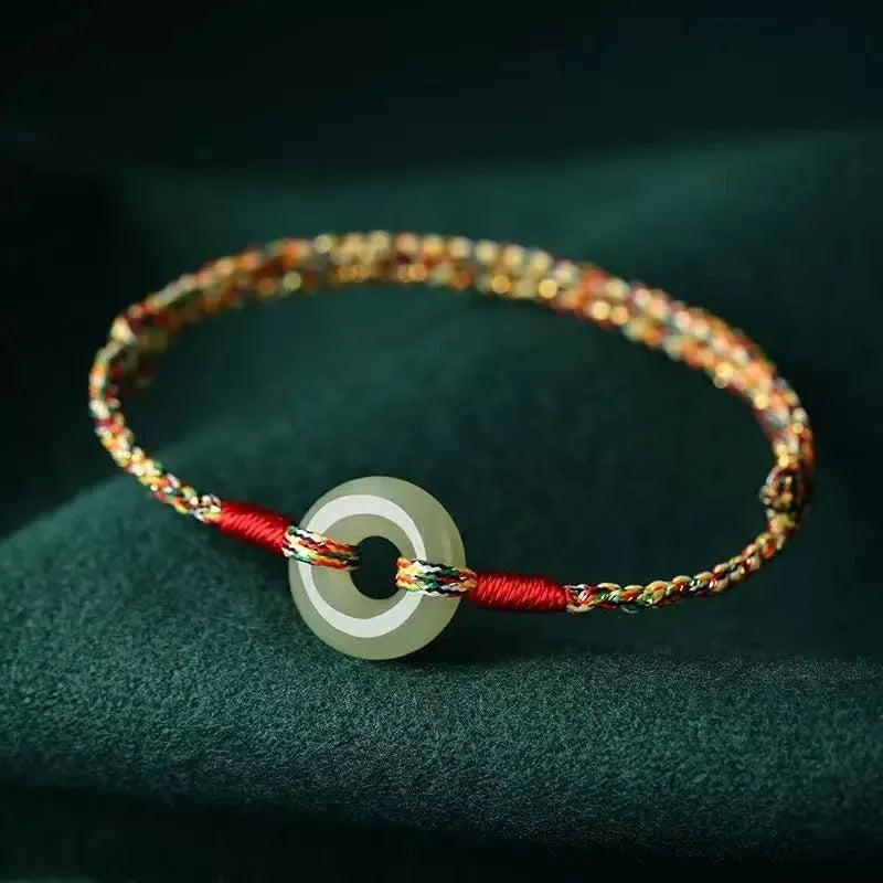 Colourful braided rope bracelet with peace buckle closure showing woven texture