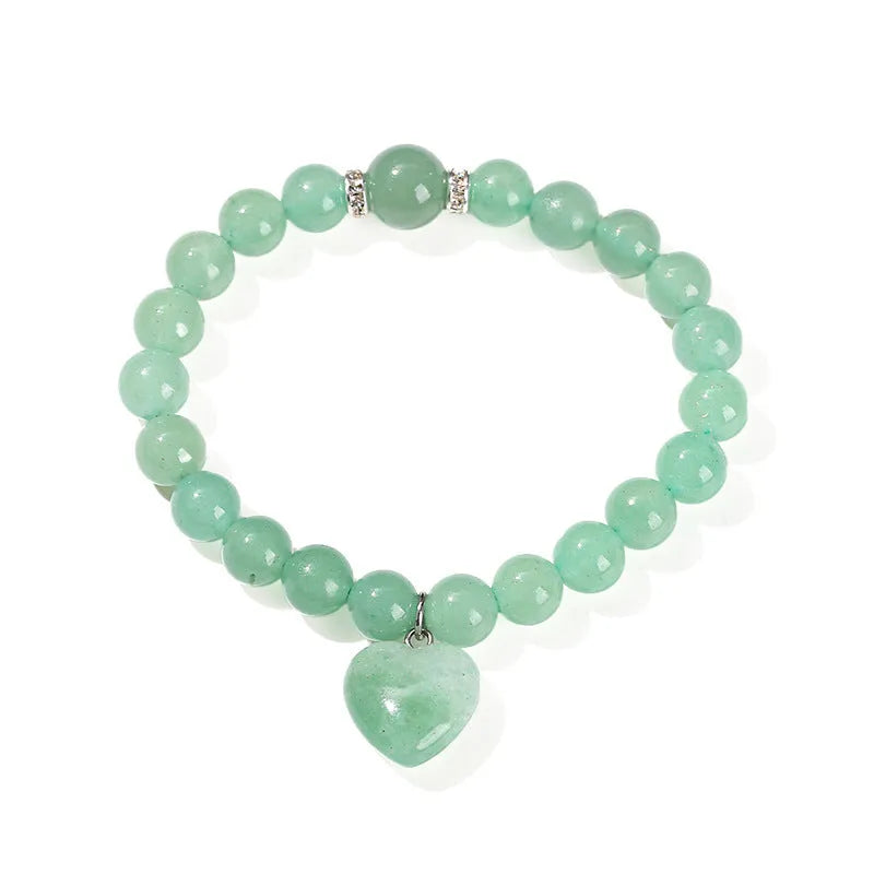 Natural crystal Tigereye love pendant bracelet with heart geometric design on woman's wrist.