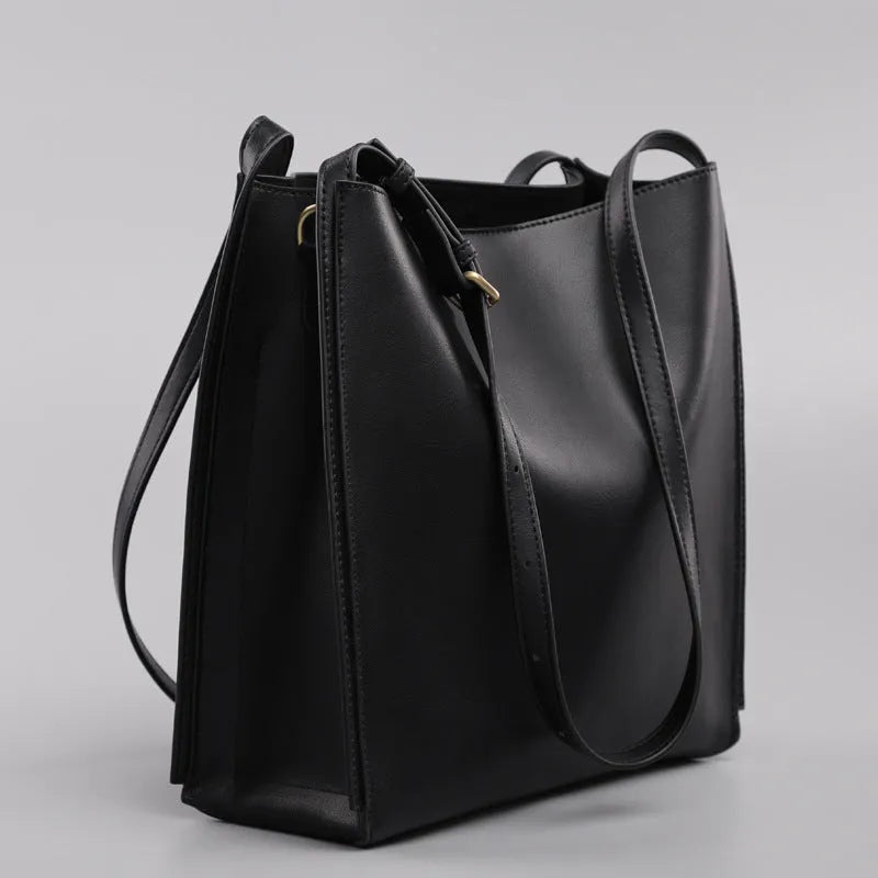 Brown genuine leather women's commuter bag with shoulder straps showing interior organisation compartments