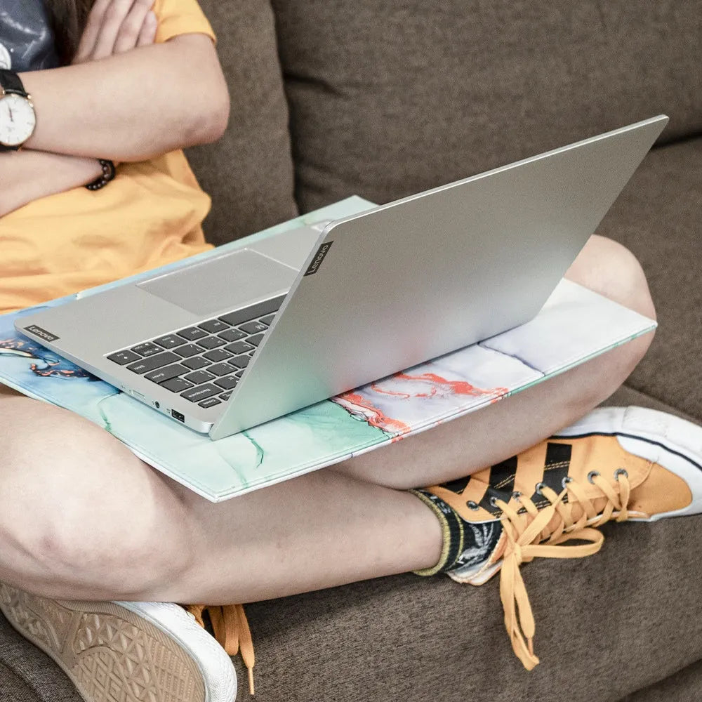Durable black laptop cooling pad with printing pattern and anti-radiation features on a desk.