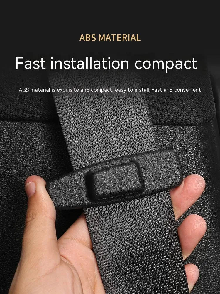 Two black ABS plastic universal car seat belt stopper clips on a white background.