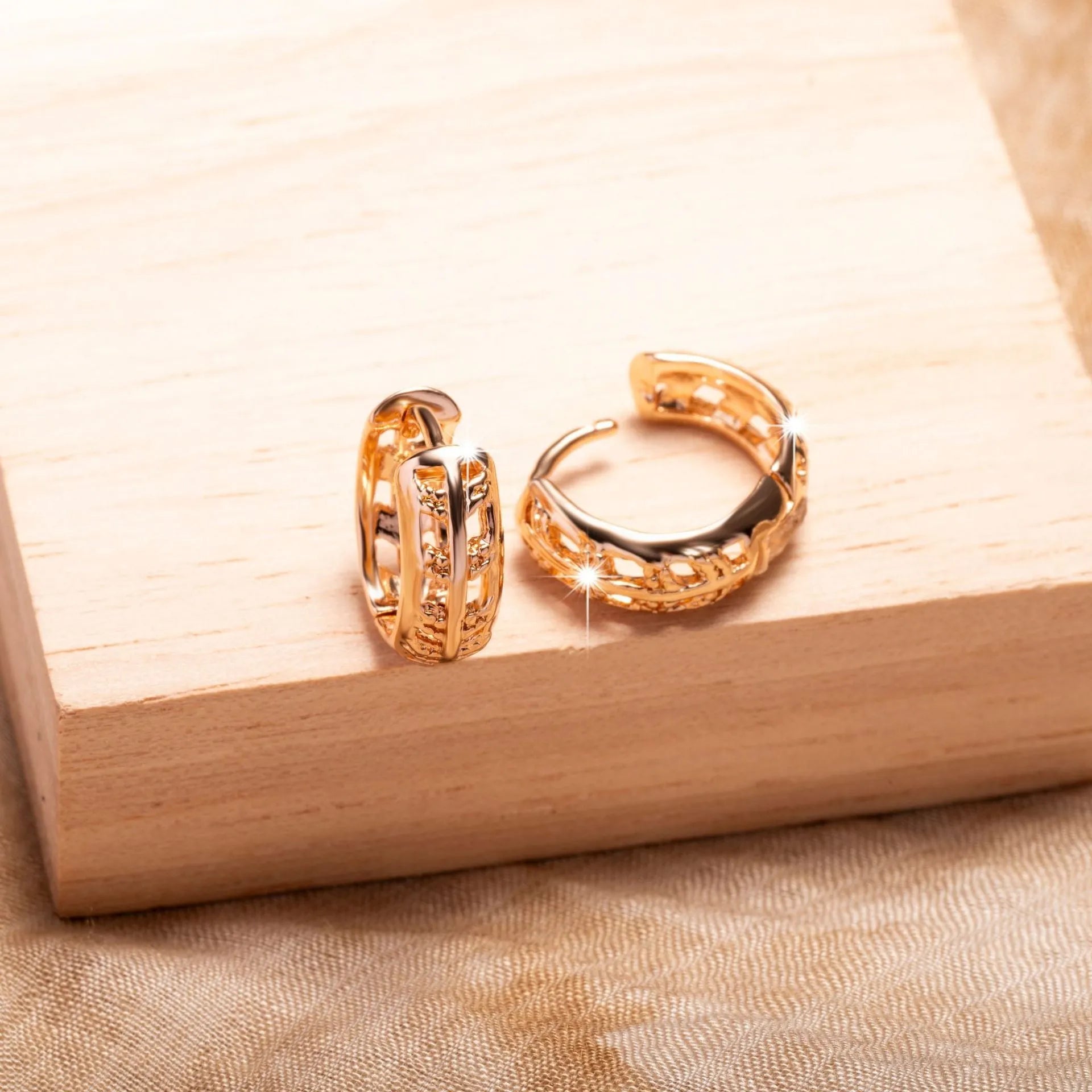 Rose gold plated hollowed-out heart and leaf shaped earrings on a white background.