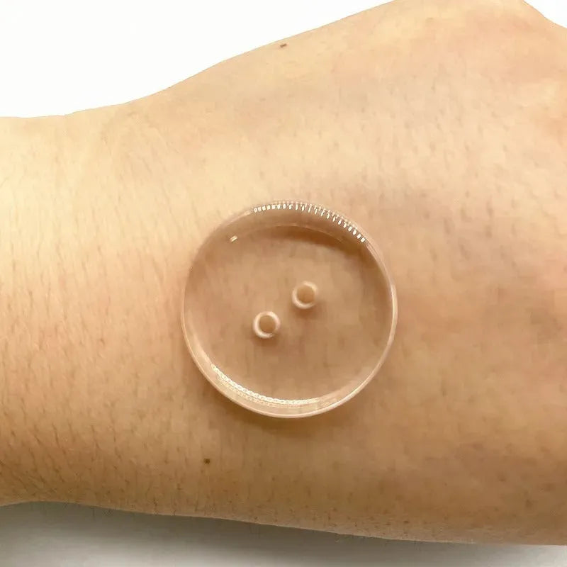 Transparent two-eye resin button 10mm on white background