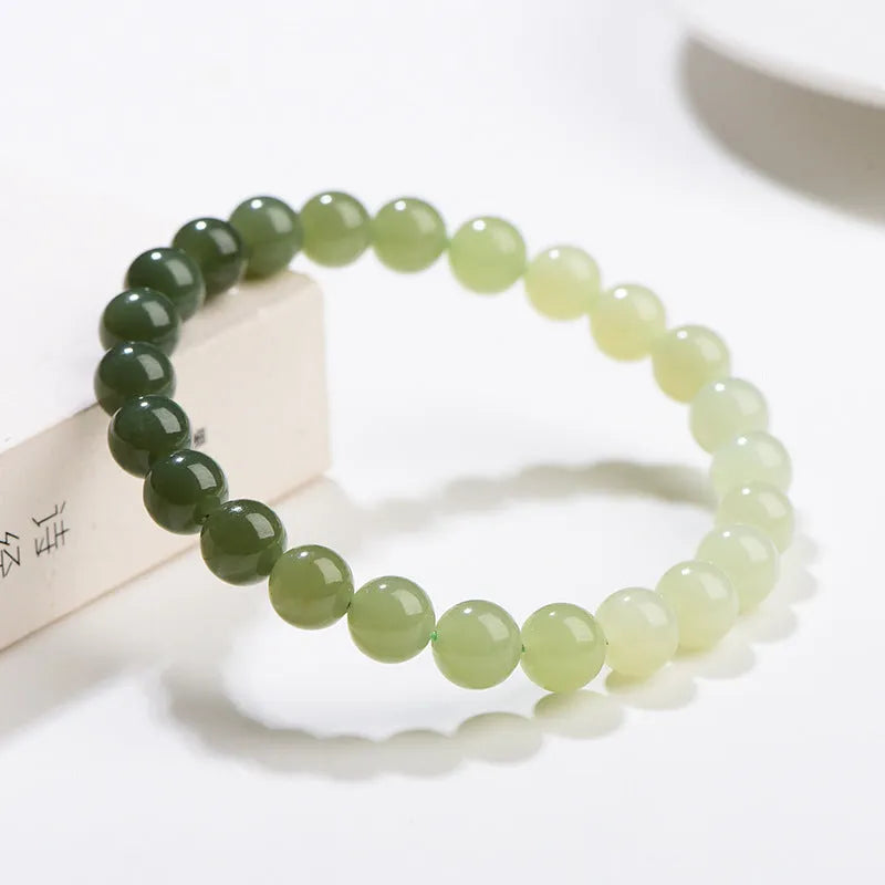 Natural clear water Hetian jade ball bracelet with round beads on a wrist.