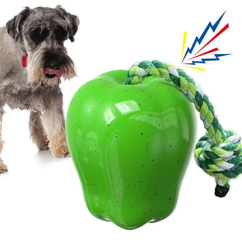 Green plastic squeaky apple dog toy for molar cleaning and outdoor fetch.