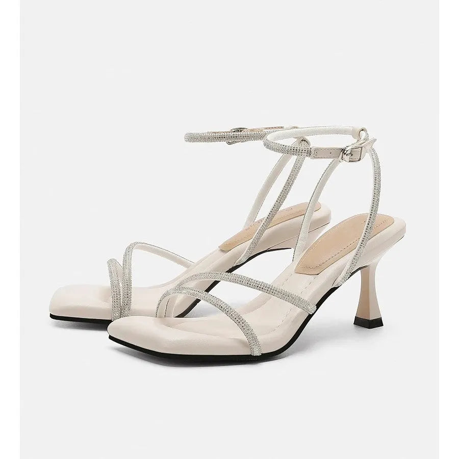 Women's silver rhinestone sandals with square toe and ankle strap buckle on a rubber sole.