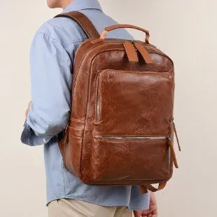 American vintage waterproof backpack 20-35L with PU lining and curved shoulder straps in black, brown, dark brown, or yellowish brown.