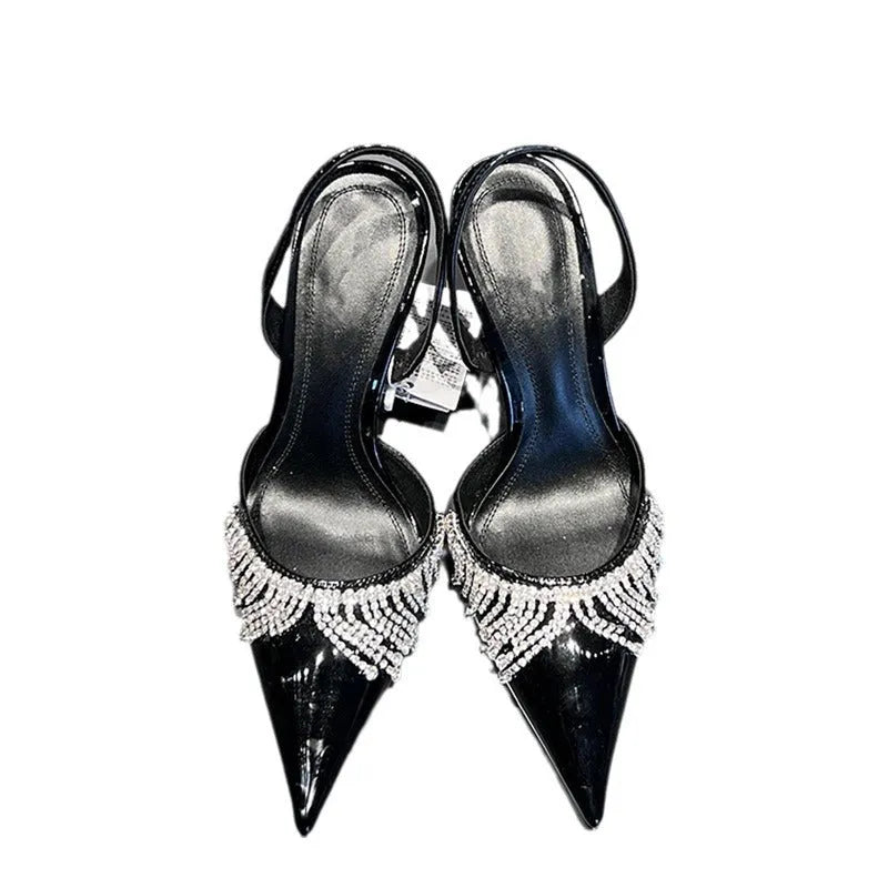 Black high heel sandals with rhinestone tassel decoration, pointed toe, and slingback strap showing 10cm stiletto heel