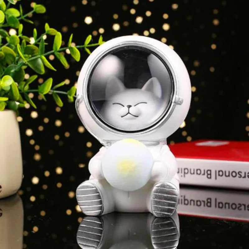 Resin bear-shaped starry sky night light with soft LED glow on a wooden table.