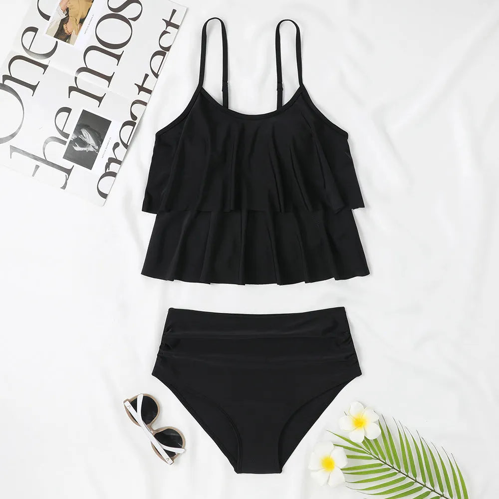 Black high waist swimsuit briefs with coconut tree print and sleeveless top on a mannequin
