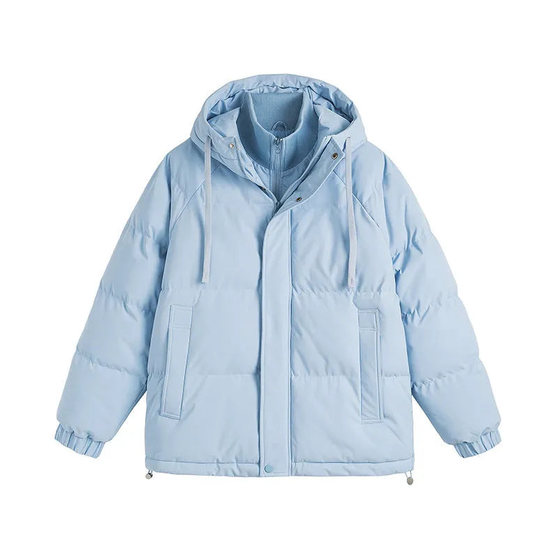 A loose, longline beige cotton-padded winter coat for men and women with side seam pockets.