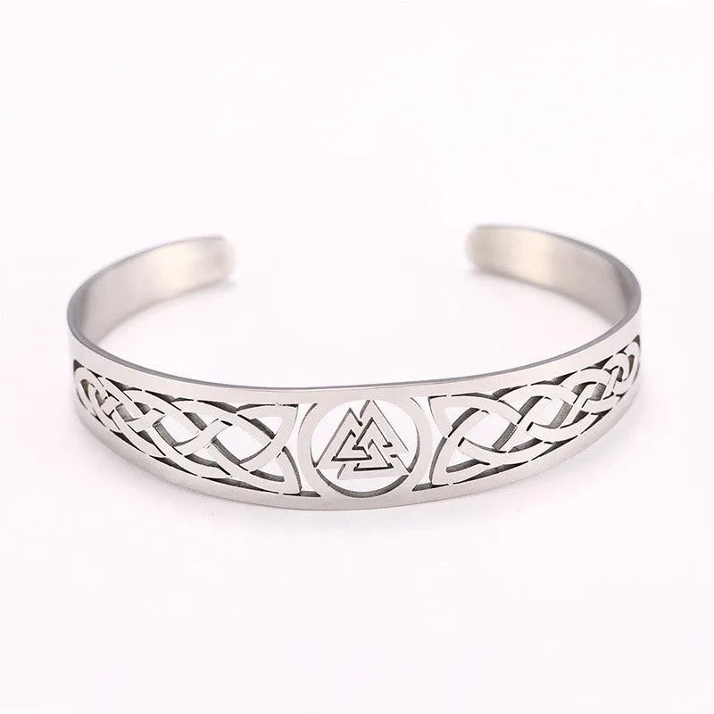 Handcrafted stainless steel bracelet with Valknut symbol and Celtic design on a neutral background