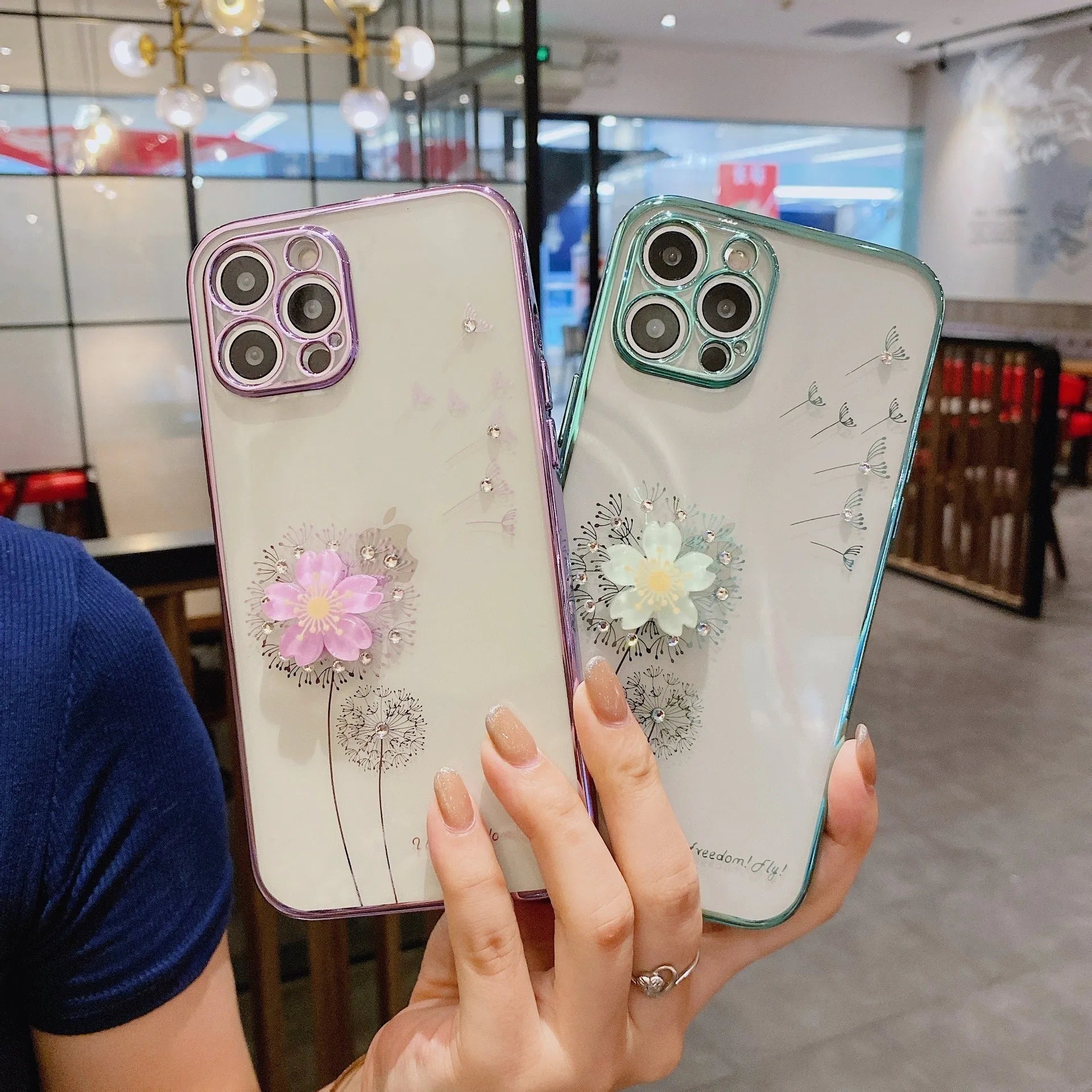 Green iPhone case with a built-in 3D white flower stand popped out, showing the phone propped up for viewing.