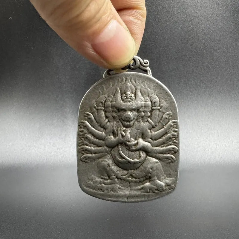 Close-up of an antique Chinese-style geometric iron pendant hanging ornament.
