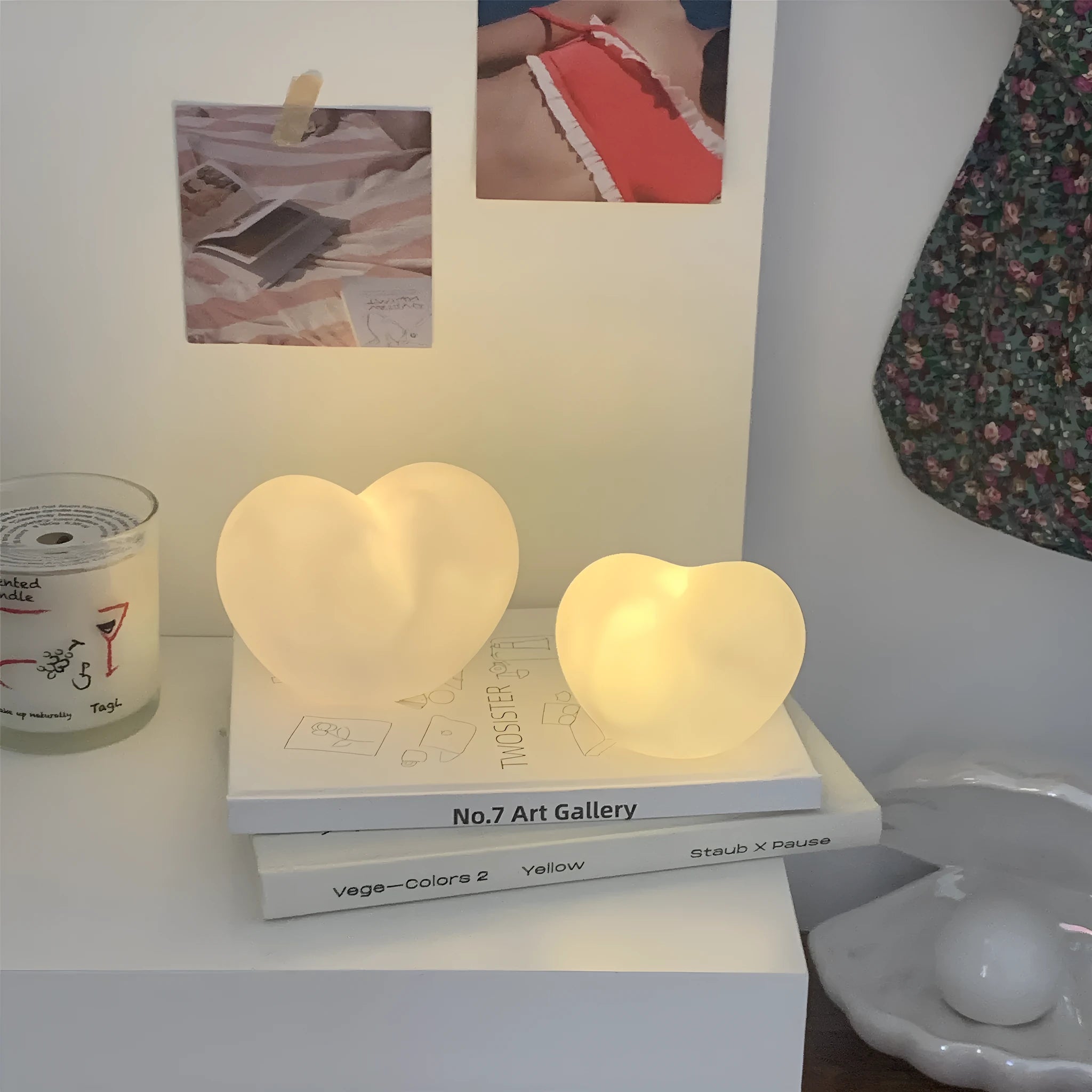 White and pink vinyl atmosphere lamp in trumpet and tuba shapes on a bedside table.