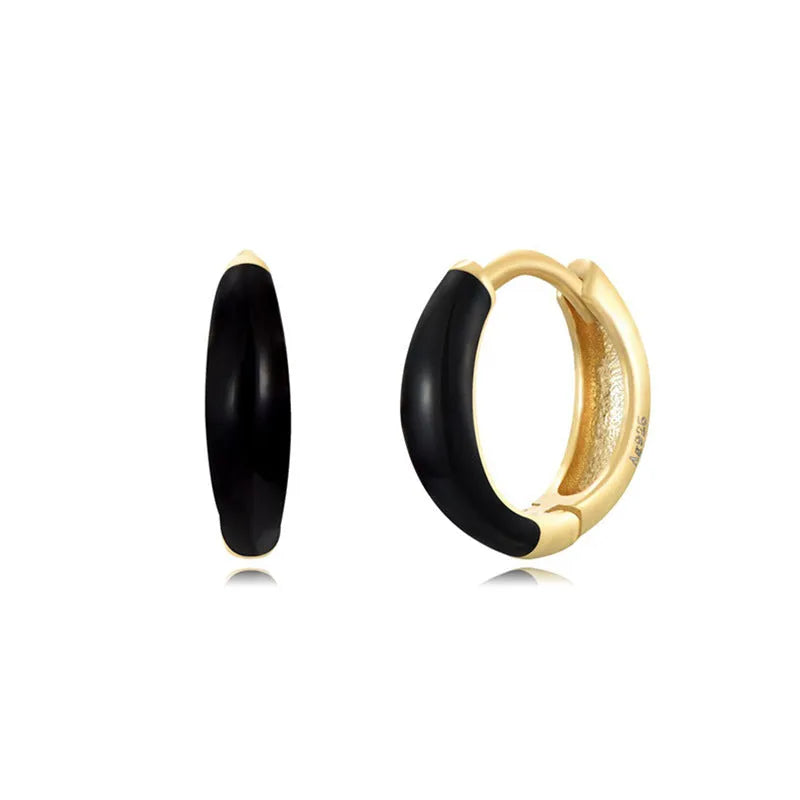 A pair of curved U-shaped epoxy earrings with a translucent blue dripped oil finish and a silver hook on a white background.