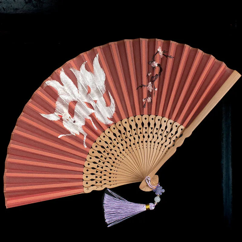 Traditional Chinese bamboo folding fan with Su embroidery patterns including orchid and butterfly designs