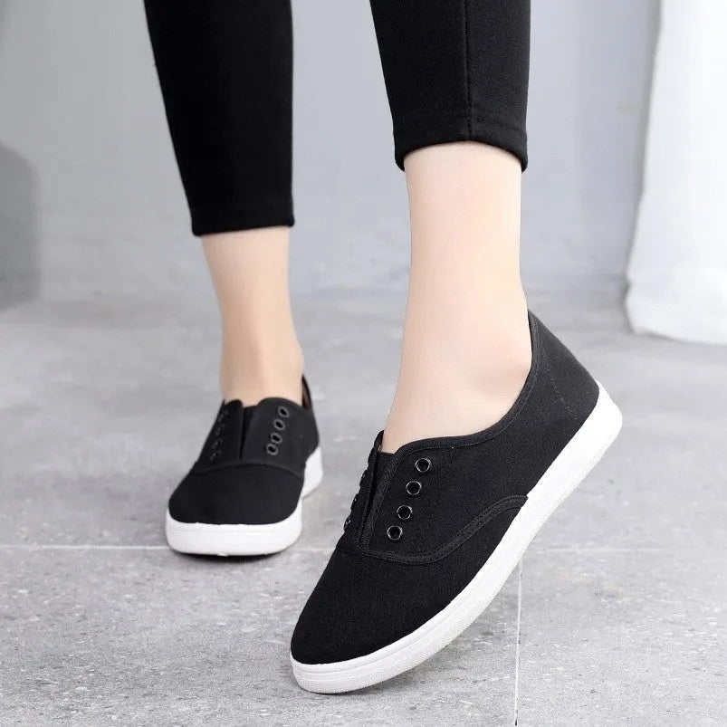 Low-top canvas casual shoes in black, grey, pink, and white colours with flat plastic soles