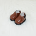 A pair of 17 cm high black doll shoes made from PU leather, shown as a keychain accessory.