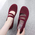 A pair of casual slip-on flat shoes with a round toe and elastic fabric upper, shown in an embroidered colour option.