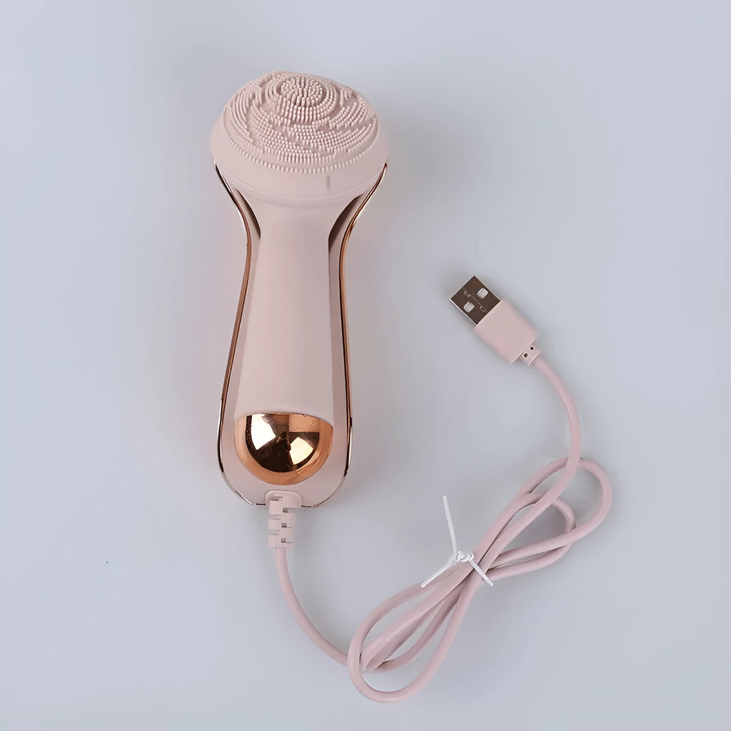 Electric face wash cleaner with pink silicone brush head on a light background