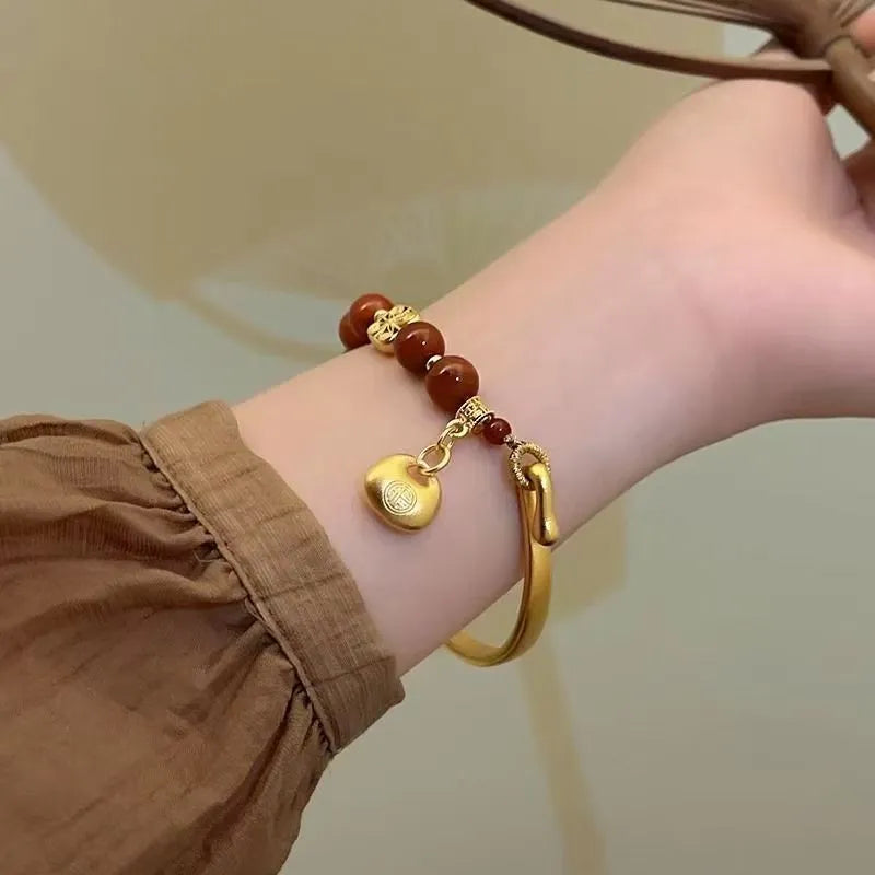 Golden south red agate character ingot bracelet handmade from glass and coloured glaze