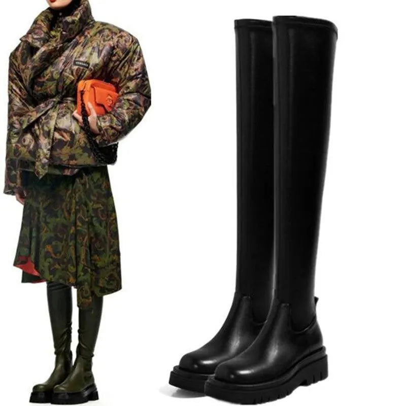 Black women's knee high boots with thick chunky sole and round toe on a winter background