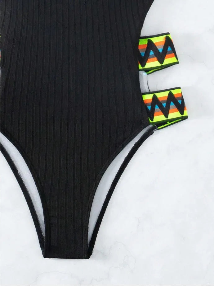 Black solid colour one-piece swimsuit for women, made from polyester fabric, laid flat.