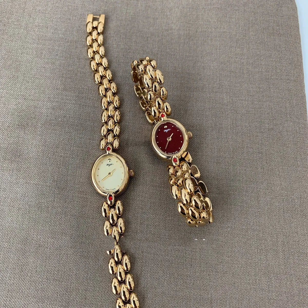 Retro oval small dial women's watch with gold alloy strap, shown in red dial and gold dial options