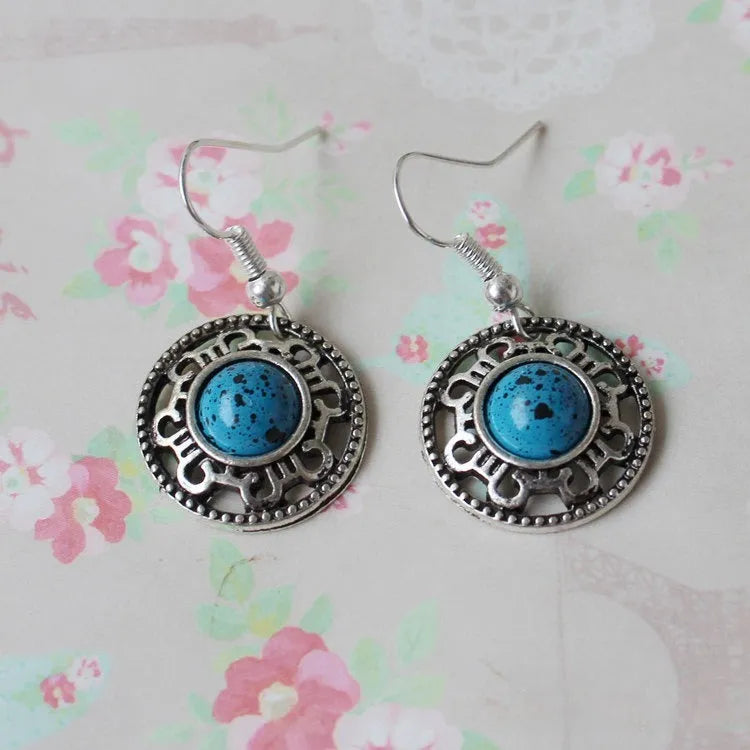 Handmade geometric Miao silver earrings with turquoise and auspicious cloud patterns in black, blue, or red.
