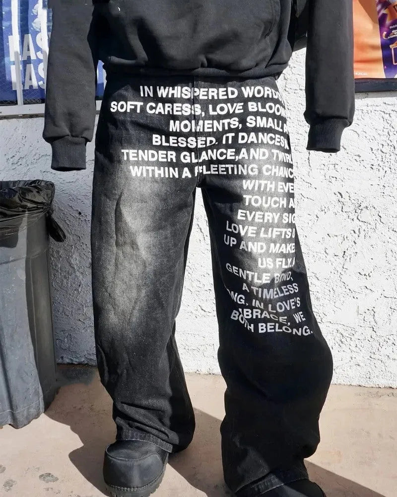 Man modelling black loose wide-leg straight cotton casual trousers with an elasticated waistband.