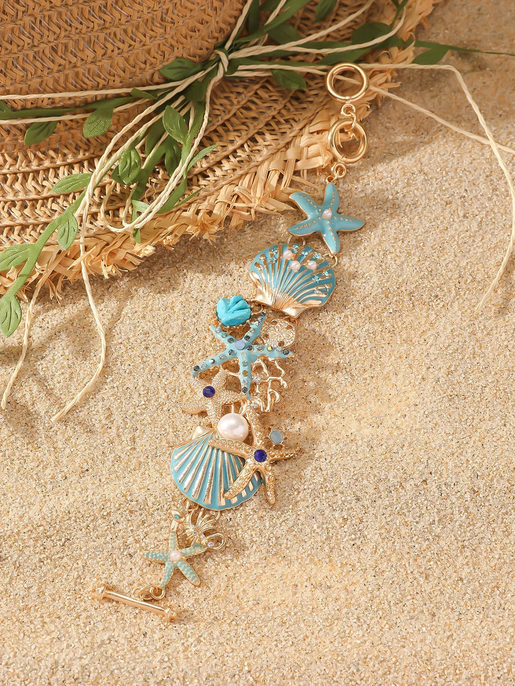 Women's alloy nautical bracelet with boat anchor, shell, and starfish charms in turquoise, red, or blue.